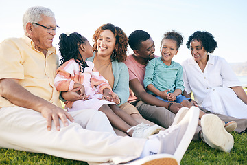 Image showing Family, smile and generations outdoor, happy people relax on lawn with grandparents, parents and kids. Happiness, unity and sitting together on grass, diversity and love with relationship and bond