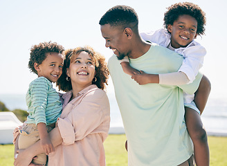 Image showing Smile, love and happy black family at beach for summer travel, vacation and piggyback in a garden. Cheerful, relaxed and trip with children and parents embrace and bond while traveling in Mexico