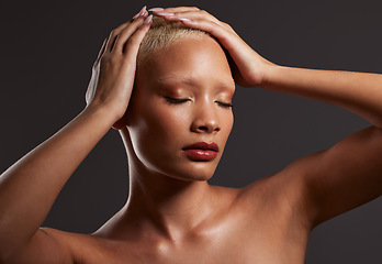 Image showing Skincare, makeup and black woman with hands on head in dark studio, platinum hair isolated on grey background. Art aesthetic, cosmetics and African beauty model and luxury spa facial for bronze skin.