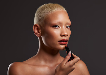 Image showing Cosmetics, makeup and portrait of woman with lipstick in studio for beauty, skincare products and fashion. Salon aesthetic, cosmetology and girl model with red gloss for lips, face and luxury style