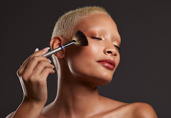 Image showing Makeup, brush and woman with cosmetics in studio for beauty products, foundation or highlighter application. Salon aesthetic, cosmetology and face of girl model for eyeshadow, facial and luxury style