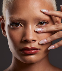 Image showing Makeup, hands on face and portrait of woman in studio for beauty products, cosmetics and skincare. Salon aesthetic, cosmetology and zoom of girl with manicure, self love and luxury on gray background