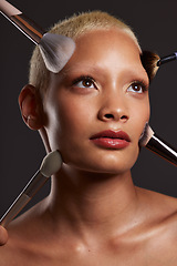 Image showing Woman, face and beauty with makeup brushes for skincare cosmetics or treatment against a gray studio background. Beautiful female model with cosmetic brushing tools for facial, self care or love