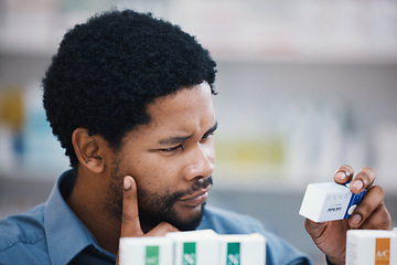 Image showing Black man, medical product and thinking in pharmacy for reading, choice and pills in retail healthcare. African customer, box and sale for health, deal and wellness for benefits of medicine in store