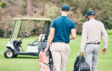 Image showing Golf, sports and men on course with golfing bag walking to cart after game, practice and training on lawn. Professional golfers, fun and back of friends on grass for exercise, fitness and competition