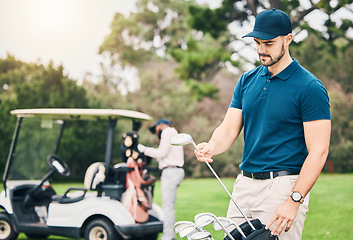 Image showing Golf, sports and man on course with golfing bag of clubs ready to start game, practice and training on lawn. Professional golfer, activity and male caddy on grass for exercise, fitness and recreation