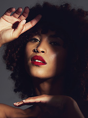 Image showing Red lipstick, shadow and makeup on black woman with beauty, afro or natural hair in studio. Face of aesthetic female model with a skin glow, shine and color on lips for art, power and facial skincare