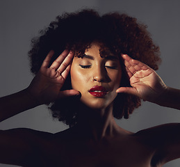 Image showing Dark, beautiful and face of a woman with makeup isolated on a black background in a studio. Stunning, glow and girl showing cosmetics, glamour and beauty, elegance and classy look on a backdrop