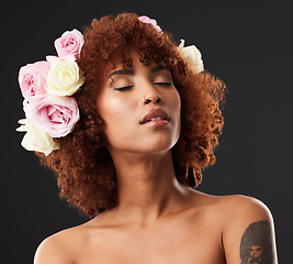 Image showing Artistic, creative and woman with flowers in hair isolated on a black background in a studio. Calm, peaceful and a beautiful girl with self love, floral look and creativity on a dark backdrop