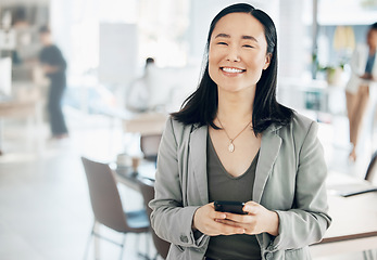 Image showing Portrait, success and Asian woman in office, smartphone and typing for social media, happiness and connection. Face, Japanese female employee and manager in workplace, cellphone and communication