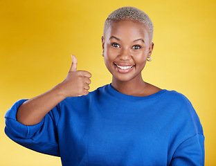 Image showing Portrait, smile and black woman with thumbs up in studio isolated on a yellow background. Success, emoji face and happy African female with hand gesture for agreement, support or approval, like or ok