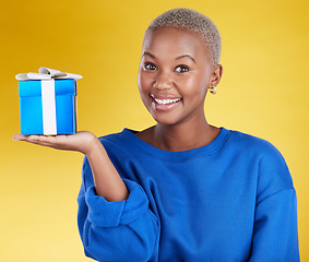 Image showing Smile, portrait and black woman with gift in studio isolated on a yellow background. Face, box and happy African female with present for celebration, party and holiday, birthday and special event.