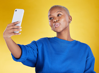 Image showing Selfie, smile and beauty of black woman in studio isolated on a yellow background. Photographer, social media and African female model taking pictures or photo for profile picture and happy memory.