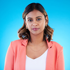 Image showing Face, portrait and business woman in studio isolated on a blue background with pride for career, profession or job. Boss, professional and confident, serious and proud female entrepreneur from India.