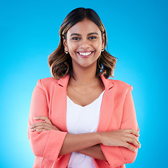 Image showing Smile, portrait and business woman with arms crossed in studio isolated on a blue background with pride for career. Face, professional and confident, happy and proud female entrepreneur from India.