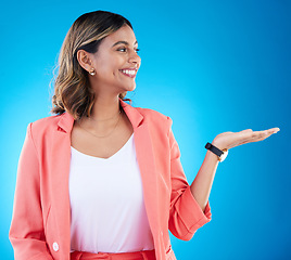 Image showing Smile, mockup and business woman with product placement in studio isolated on a blue background. Mock up, promotion and happy Indian female with palm for advertising, marketing or branding space.