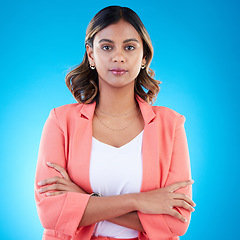 Image showing Serious, portrait and business woman with arms crossed in studio isolated on blue background with pride for career. Face, professional and confident, assertive or proud female entrepreneur from India