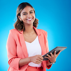 Image showing Tablet, smile and portrait of business woman in studio isolated on a blue background. Technology, professional and happy, proud and confident female from India with touch screen for internet browsing