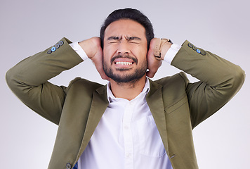 Image showing Business, stress and Asian man cover ears, loud and mental health against a grey studio background. Male employee, anxious worker and entrepreneur with hands on temple, noisy and blocking for silence