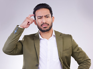 Image showing Confused, decision and an Asian man thinking with a gesture isolated on a white background in a studio. Doubt, think and a Japanese businessman with a choice, pensive and thoughtful on a backdrop