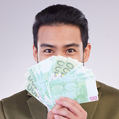 Image showing Portrait, cash and euro with a business man in studio holding money on a gray background for finance. Smile, accounting or investment with a happy male employee proud of his financial trading success