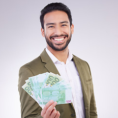 Image showing Money, cash and happy man face isolated on a white background business wealth, bonus or investing profit. Winner, banking or rich accountant or Asian person with financial freedom in studio portrait