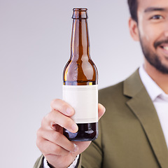 Image showing Man face with beer bottle isolated on a white background for alcohol product promotion drink, happy hour and cheers. Professional Asian person or model hand holding wine glass container in studio