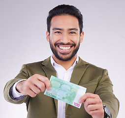 Image showing Portrait, money and euro with a business man in studio holding cash on a gray background for finance. Smile, accounting or investment with a happy male employee proud of his financial trading success