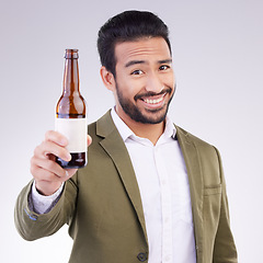 Image showing Portrait of happy man with beer bottle isolated on a white background for alcohol product promotion and cheers. Professional Asian person or model face and hand holding wine glass container in studio