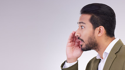 Image showing Mockup, secret and Asian man with gossip, whisper and talking against a grey studio background. Japan, male and guy with privacy, space and announcement with person, sharing opinion and mysterious