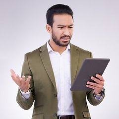 Image showing Problem, confused and Asian man with a tablet for communication isolated on a white background in a studio. Unhappy, frustrated and a Japanese businessman reading bad news on technology on backdrop