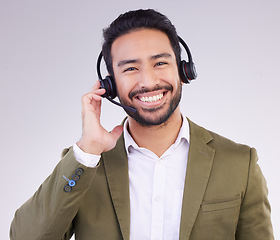 Image showing Call center portrait of happy man isolated on a white background for telemarketing, telecom or global support. Asian international agent, consultant or business person for virtual salesman in studio