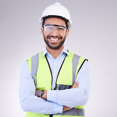 Image showing Construction worker in portrait, man with crossed arms and smile, architect or engineer in building industry on studio background. Happy contractor, professional builder with helmet and goggles