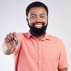 Image showing Real estate, happy and portrait of a black man with keys isolated on a white background in a studio. Smile, pride and African guy showing a key to a new home, house or apartment as a property owner