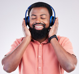 Image showing Black man, studio and headphones for streaming music to relax, listen and free mindset by background. Happy african model, audio and sound for peace, mindfulness and online podcast with smile on face