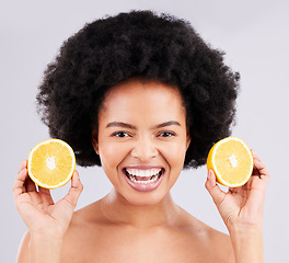 Image showing Skincare, portrait and orange by black woman in studio for vitamin c, wellness or skin detox on grey background. Face, fruit and girl model excited for citrus treatment, cosmetics or beauty routine