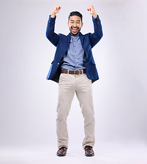 Image showing Winner, celebration and portrait of man with excited, cheering and achievement on white background. Success, winning mockup and isolated happy male with fists in air for victory, bonus and good news