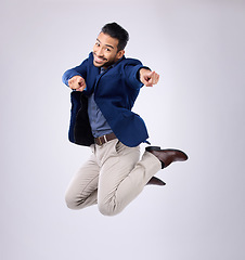 Image showing Jump, excited and portrait of man point in studio with surprise, happiness and celebration on white background. Winner, success mockup and isolated happy male jumping with energy, smile and victory