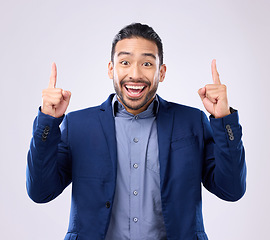 Image showing Excited man, business and pointing hands at space in studio for motivation and advertising. Asian male and happy model portrait on gray background with fingers up for mockup promotion announcement