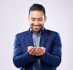 Image showing Plant in happy man hands for business growth isolated on a white background in eco friendly investment. Asian person with sapling soil in palm for sustainable startup and green investing in studio