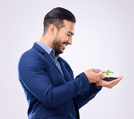 Image showing Happy man with plant in hands isolated on a white background business growth or eco friendly investment. Asian person with sapling soil in palm for sustainable startup and green investing in studio