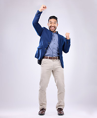 Image showing Celebration, excited and portrait of man with fist in air for, happiness, success and bonus on white background. Winner, smile and isolated happy male in studio celebrate winning, good news and deal