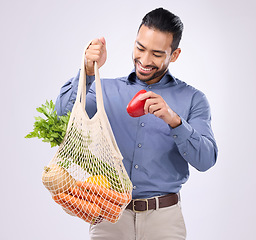 Image showing Healthy, happy and an Asian man grocery shopping with a bag isolated on a white background in a studio. Smile, choice and a Japanese male with food from a supermarket for a diet and nutrition