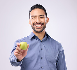 Image showing Apple, portrait and man happy with fruit for weight loss diet, studio healthcare or body detox. Wellness food, nutritionist lifestyle person and male vegan giving product isolated on gray background