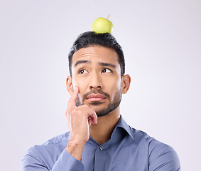 Image showing Apple, head balance and man thinking of fruit product choice for weight loss diet, healthcare food or detox. Nutritionist face, studio person and contemplating male vegan isolated on gray background