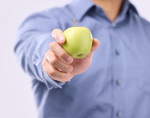Image showing Apple, studio hands and man with product for weight loss diet, healthcare lifestyle or body detox. Wellness food benefits, nutritionist person and male vegan giving fruit isolated on gray background