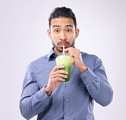 Image showing Portrait of man drinking smoothie isolated on white background diet, detox and healthy breakfast choice. Asian business person with green juice for nutrition, energy protein or vegan drink in studio