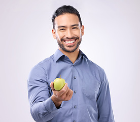 Image showing Apple, studio portrait and man happy with product for weight loss diet, healthcare lifestyle or body detox. Wellness food, nutritionist person and male vegan giving fruit isolated on gray background