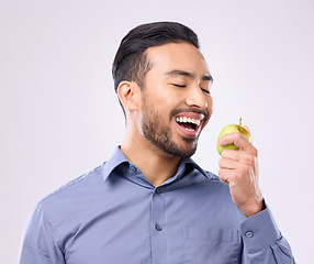 Image showing Hungry, eating and an Asian man with an apple isolated on a white background in a studio. Health, food and a Japanese male with fruit for nutrition, diet or hunger during lunch on a backdrop