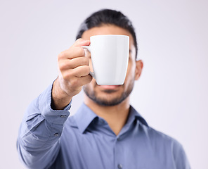 Image showing Hand, coffee cup and studio with business man for drink, energy and health to start morning by background. Businessman, young entrepreneur and holding mug for tea, latte or matcha by gray backdrop